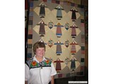 Jane Hamilton displaying one of her scrap quilts during 